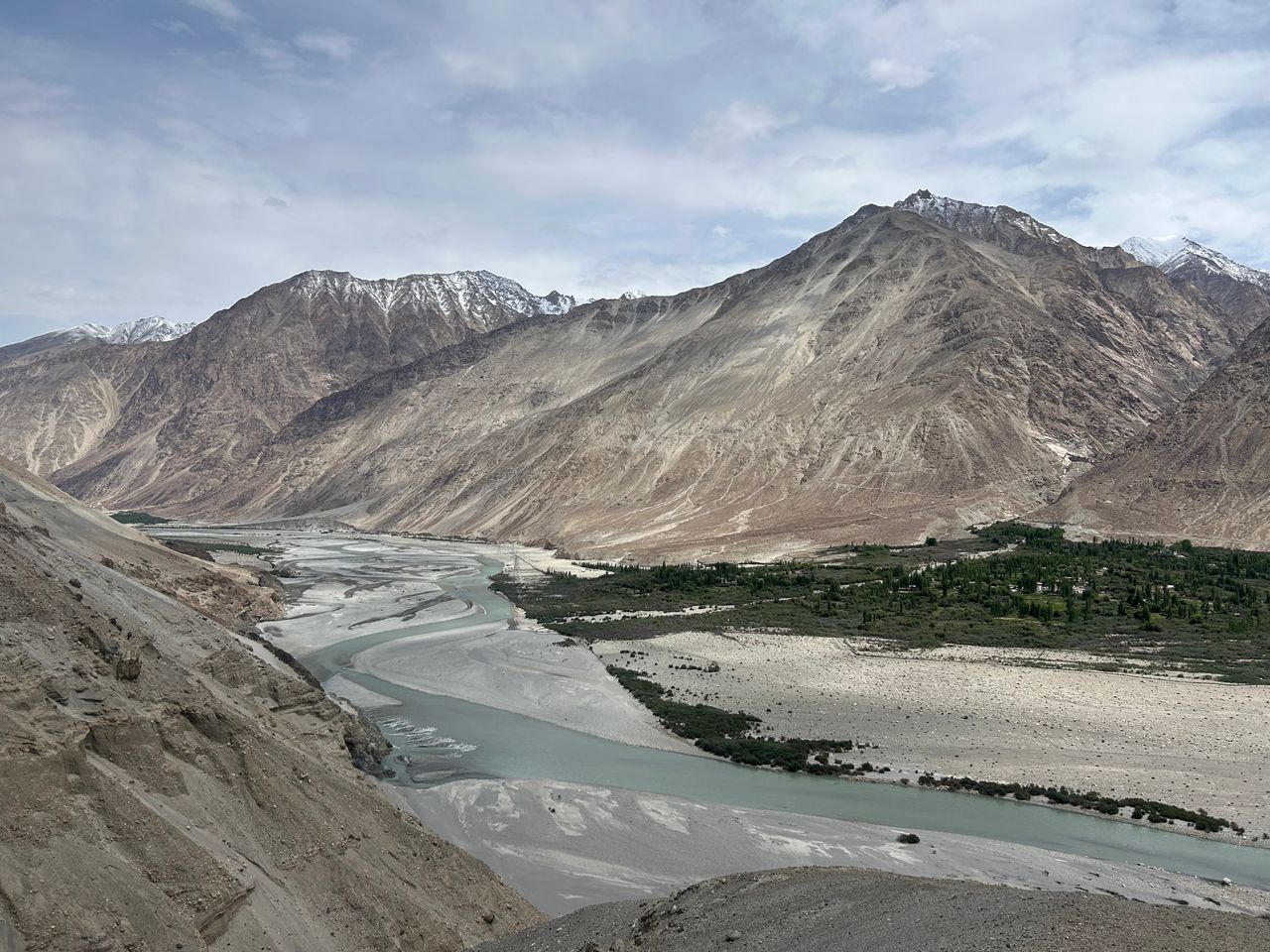 A stunning view of the mountain valley and river in Ladakh, India under a clear sky.